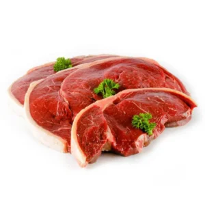 Slices of raw red meat on white surface, garnished with parsley.