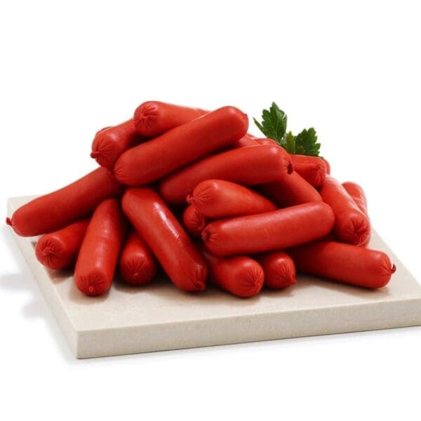 Pile of red sausages on a white board with parsley garnish.