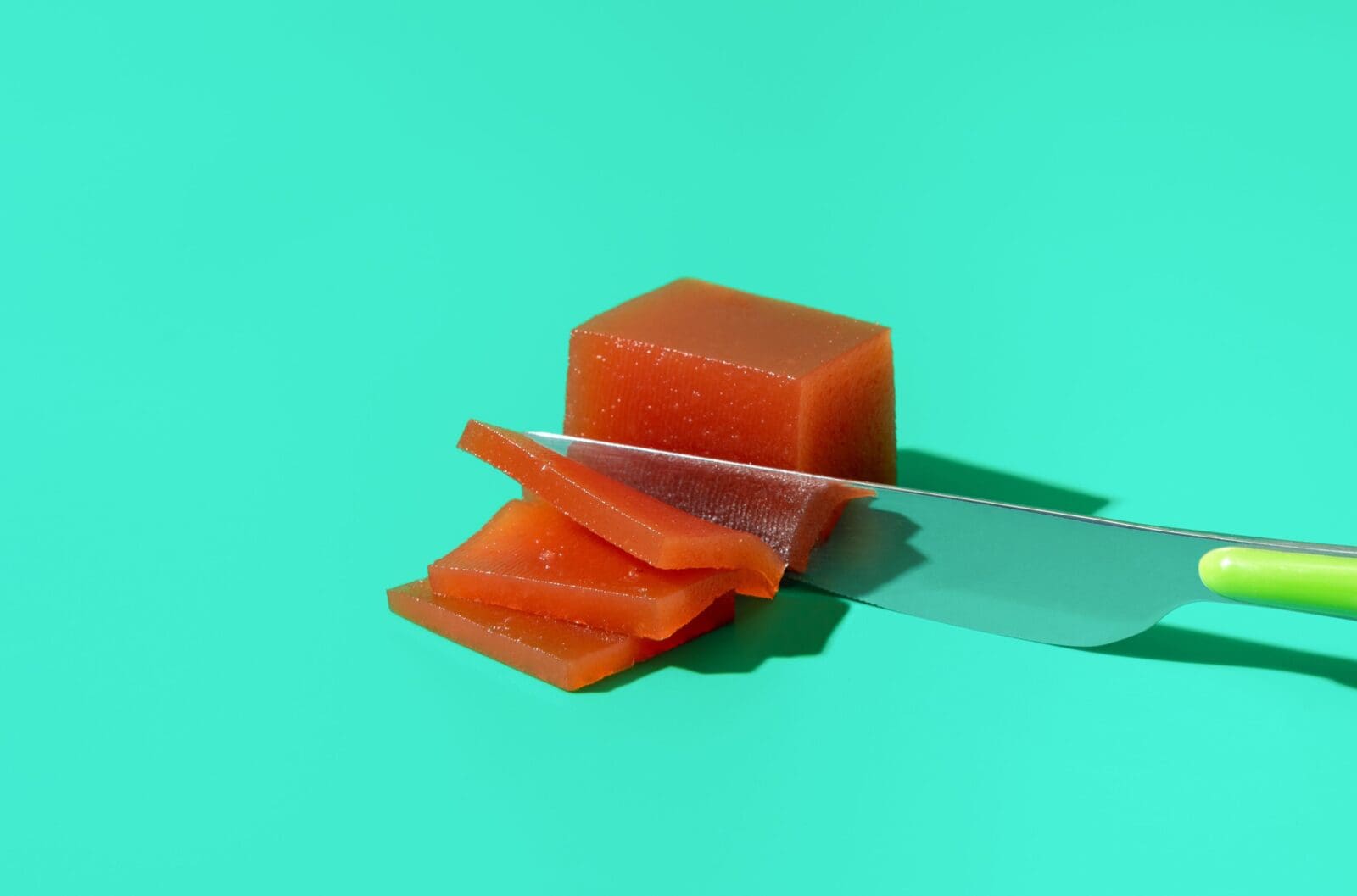 Cutting,Slices,From,A,Chunk,Of,Homemade,Quince,Marmalade,,Minimalist