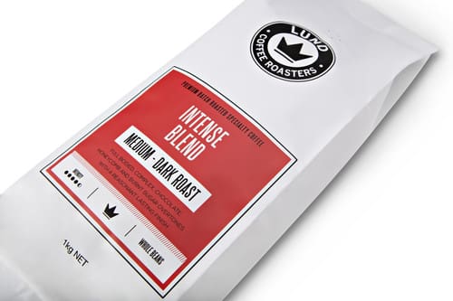White coffee bag with red "Intense Blend" label, medium-dark roast, 1 kg by Lund Coffee Roasters.