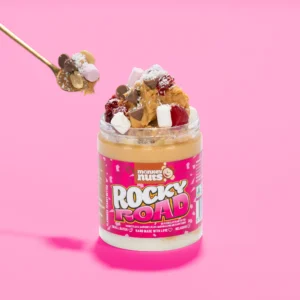 Jar of Monkey Nuts Rocky Road peanut butter topped with marshmallows, chocolate chips, and coconut.