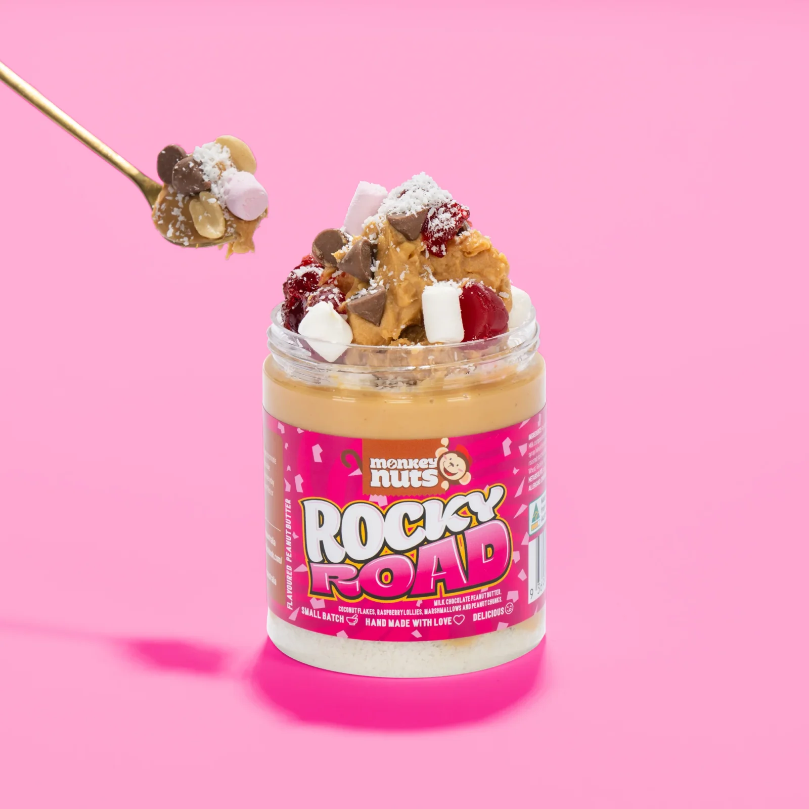 Jar of Monkey Nuts Rocky Road peanut butter topped with marshmallows, chocolate chips, and coconut.