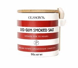 Container of Olsson's Red Gum Smoked Salt with wooden lid, spoon, red stripes, 90g net weight.