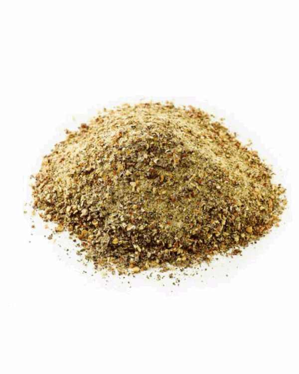 Ground spice blend mound, brown and yellow, dry, granular texture for cooking or flavoring.