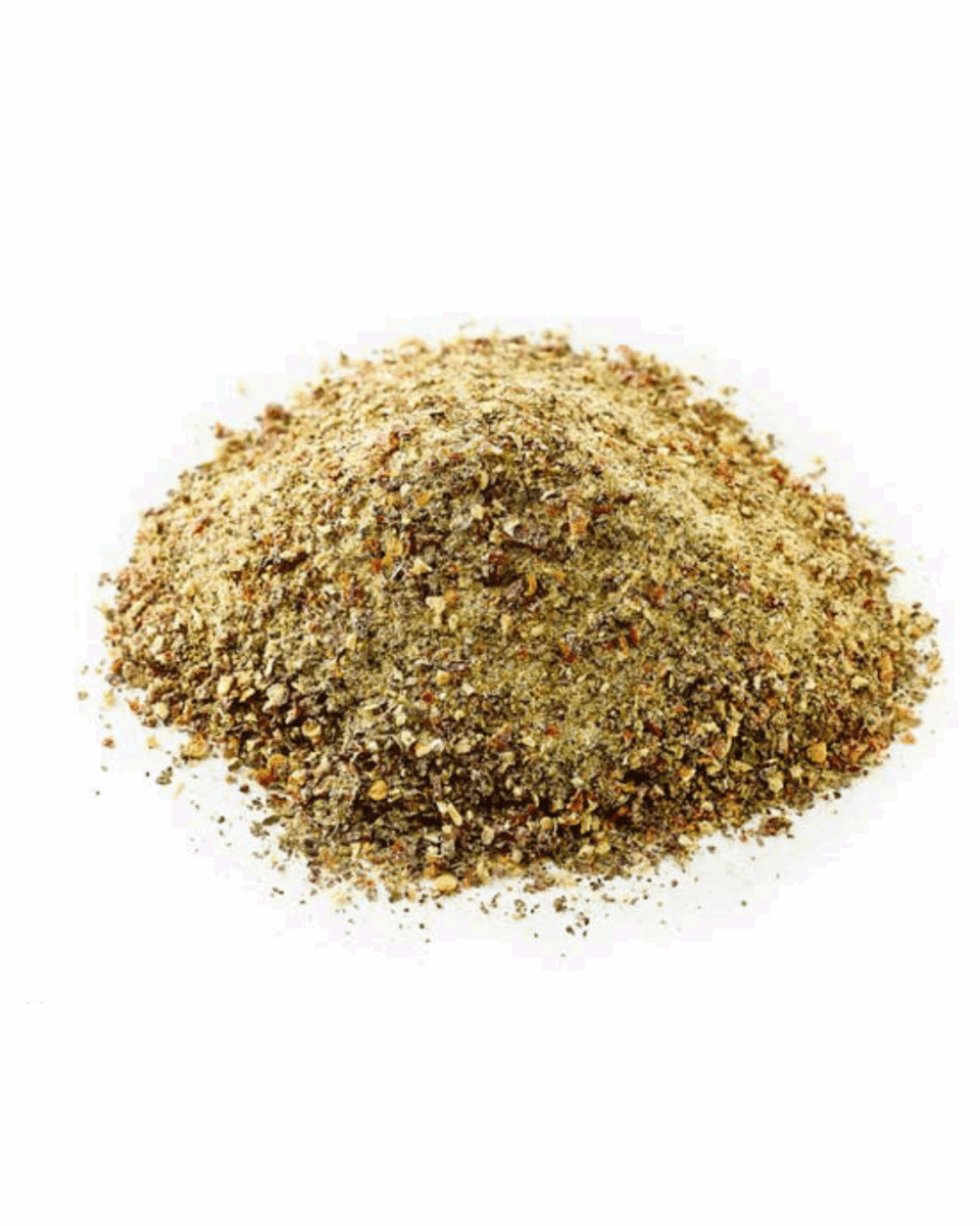 Ground spice blend mound, brown and yellow, dry, granular texture for cooking or flavoring.