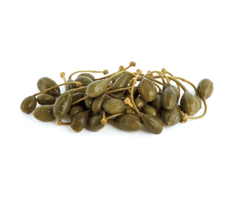 Green caper berries with stems arranged in a pile on a white background.