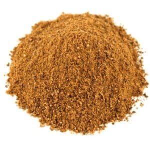 Brown, coarse ground spice pile on a plain white background, mixing granules and powder.