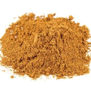 Brown, finely ground spice on white background for cooking or seasoning.