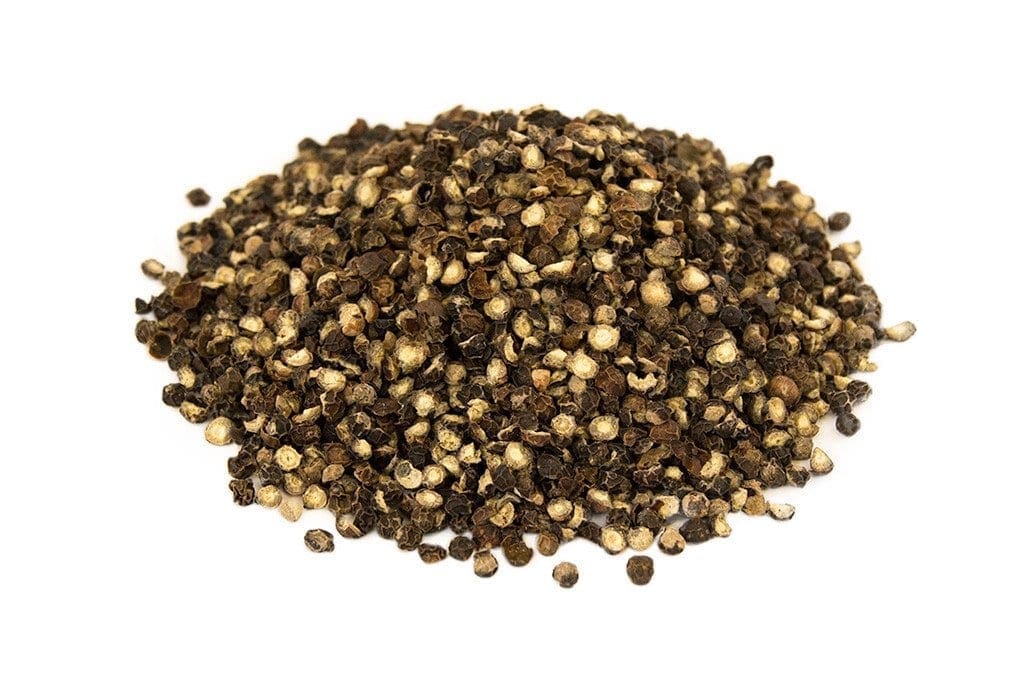 Dried cracked black peppercorns in various shades on a plain white background.