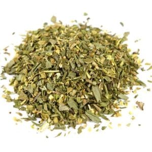 Pile of dried mixed herbs with green and brown leaves in varied sizes and coarse texture.