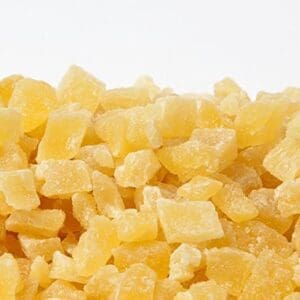 Small, cubed, dried pineapple pieces with sugary coating, light yellow color.