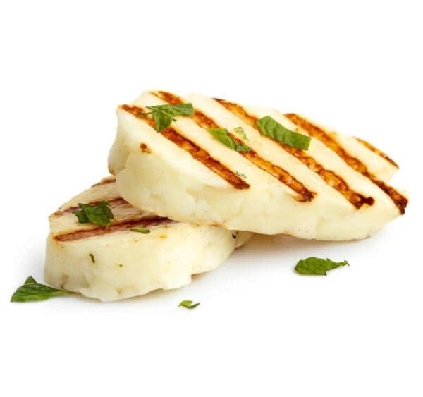 Grilled Halloumi with Fresh Herbs Grilled halloumi slices with herbs on white background.