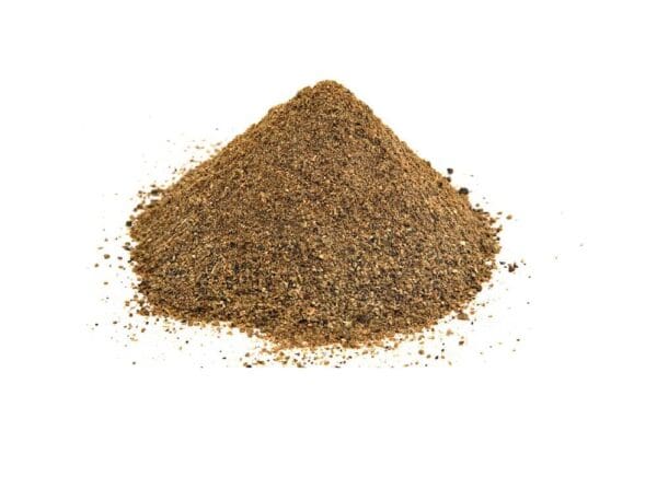 Ground black pepper in a conical pile on white background, coarse texture, dark with light specks.