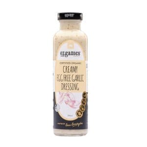 Ozganics organic creamy egg-free garlic dressing in a clear bottle with black cap and garlic label.