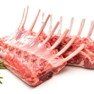 Two racks of raw lamb ribs with fresh rosemary sprigs on a white surface.