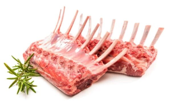 Two racks of raw lamb ribs with fresh rosemary sprigs on a white surface.