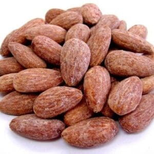 Roasted almonds pile with brown, textured surface and dry exterior typical of such nuts.