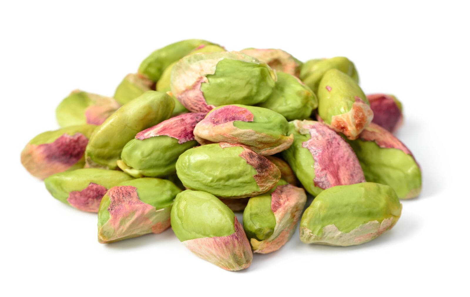 Cluster of unshelled pistachios on a white background, showing green and purple hues.