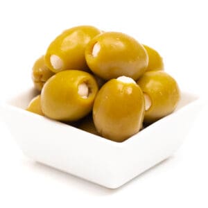 Small white bowl of green olives with cream-colored stuffing, on a plain white background.