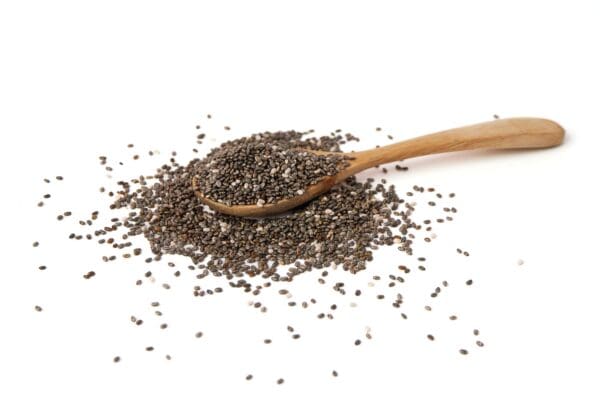 Chia seeds on a spoon with a white background