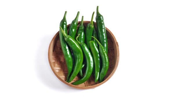 CHILLIES GREEN Basket of fresh green chili peppers on a white background