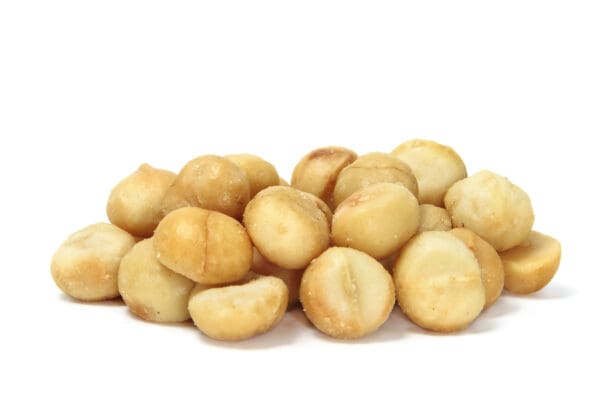 AEGEAN MACADAMIA SALTED ROASTED Pile of round, shelled, light brown nuts on a white background.