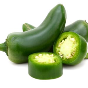 Green jalapeño peppers on white background; some whole, one sliced showing seeds inside.