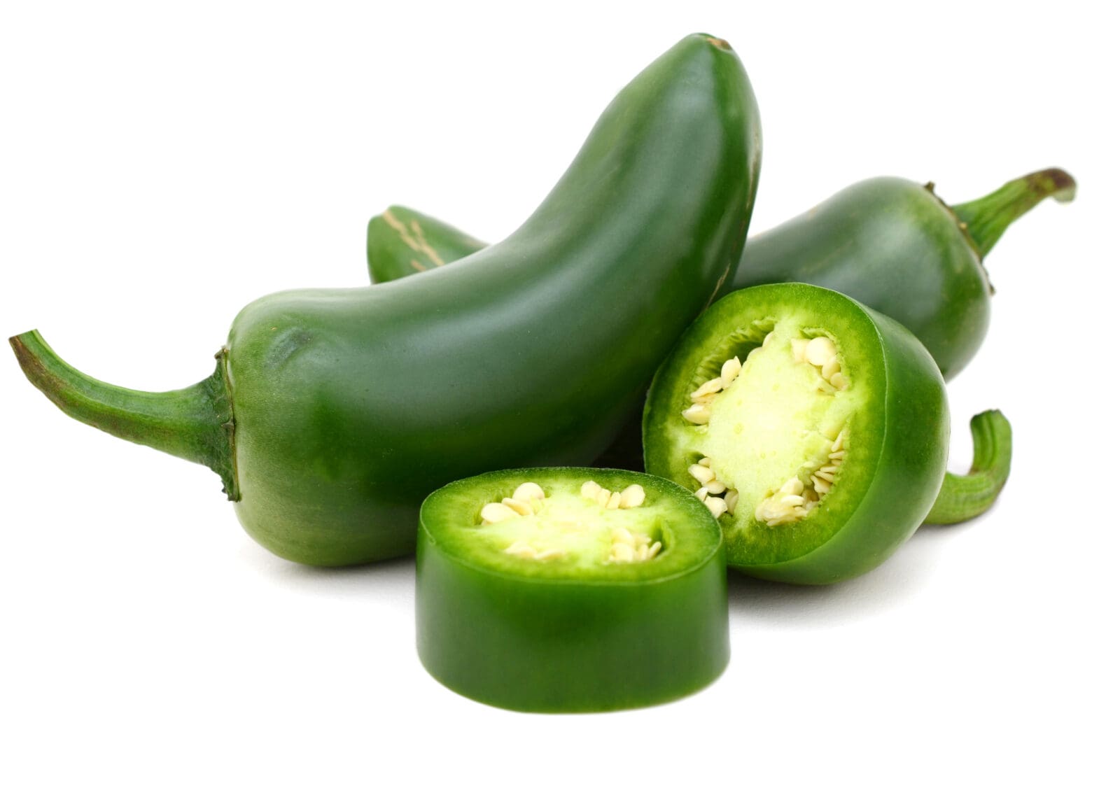 Green jalapeño peppers on white background; some whole, one sliced showing seeds inside.
