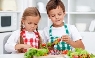 Two kids creating fresh vegetable salad - Online Food Shopping - Zone Fresh