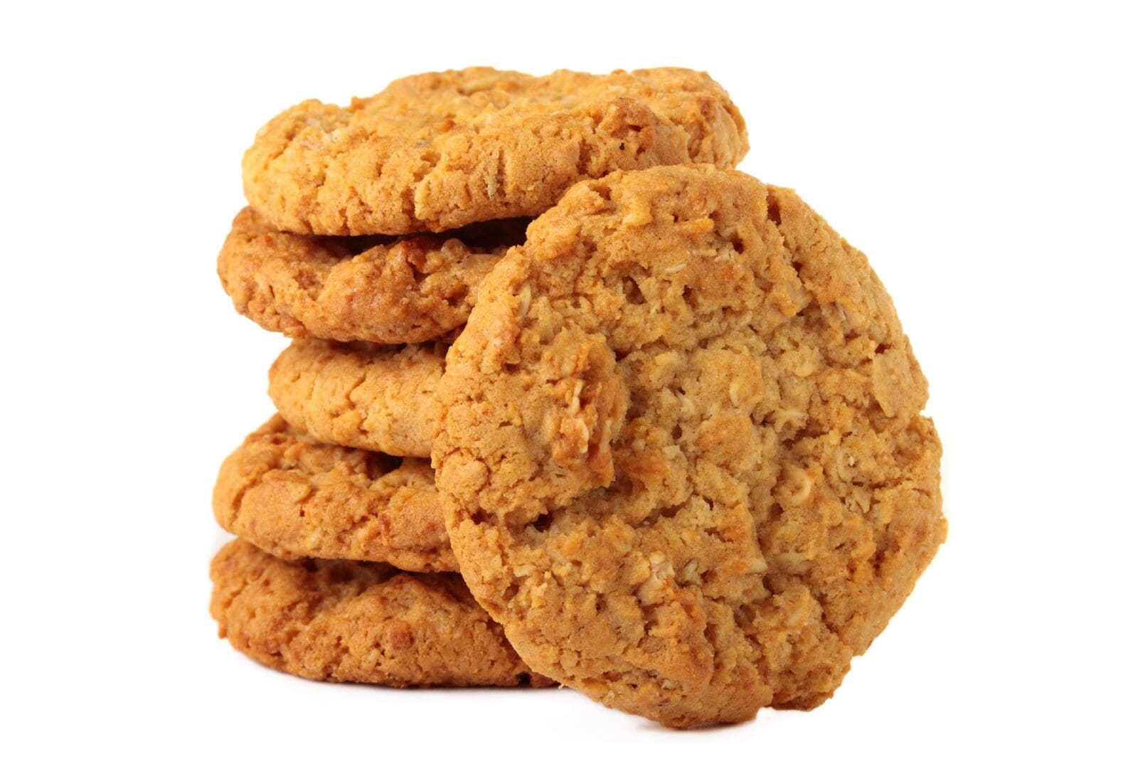 Stack of round oatmeal cookies with rough texture, golden-brown color on white background.