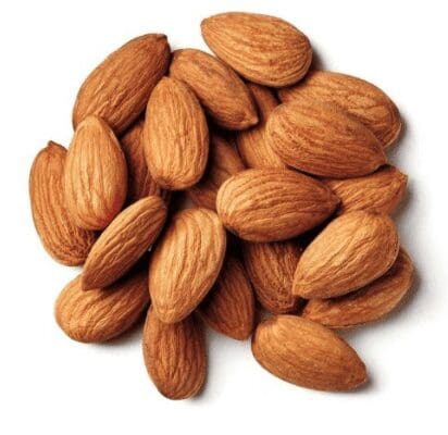 Whole almonds with brown textured skins scattered on a plain white background.