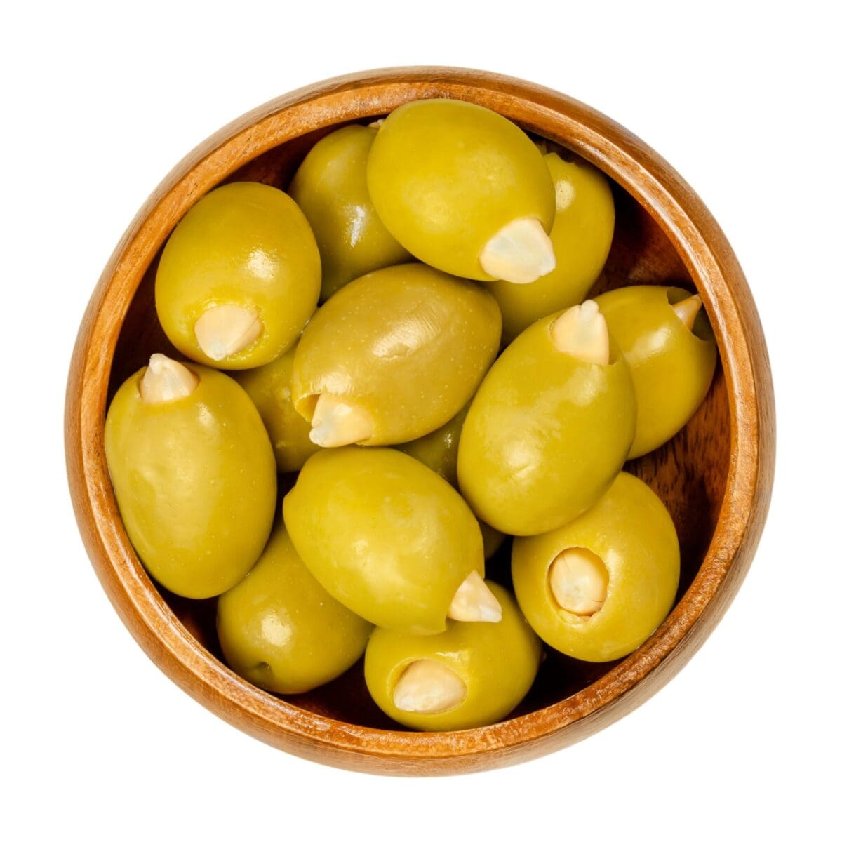 Wooden bowl with green olives stuffed with garlic pieces.