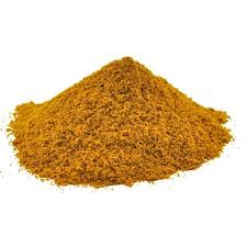 Pile of yellow-brown granulated powder on a white background, resembling a common seasoning.
